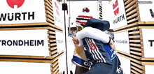 two people hugging in front of a sign that says worth
