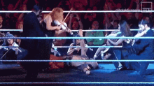 a group of people are playing violins in a ring .