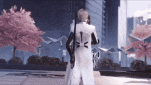 a man in a white suit is holding a sword in front of a building that says hk