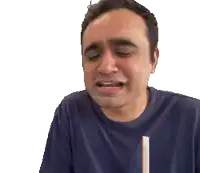 a man in a blue shirt has his eyes closed and his mouth open