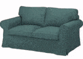 a man is laying on a blue couch in a living room with his legs crossed .
