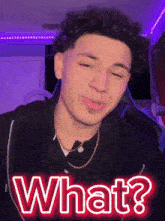a young man with curly hair is wearing a black shirt and a gold chain and says what ?
