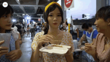 a girl holding a tray of food in front of a sign that says " dont enter "