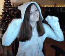 a girl wearing a white hoodie with a cat ear on it
