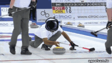 a curling game is being played in front of a ciroc advertisement