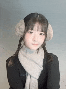 a girl wearing ear warmers and a scarf