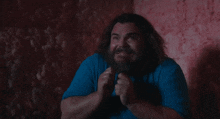 a man with long hair and a beard is making a face
