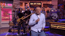 a man is dancing in front of a sign for bar aufs maul