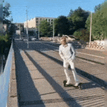 a man is riding a skateboard on a bridge .