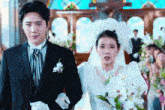 a bride and groom are walking down a aisle in a church