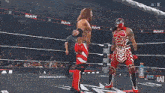 two wrestlers are standing in a ring with the word raw on the side
