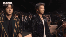 a man making a surprised face in front of a mama 2013 mama logo