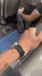 a person with a watch on their wrist is using a computer