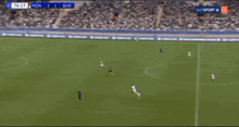 a soccer game is being played in a stadium and the score is 2 to 1