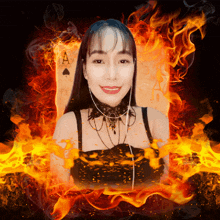 a woman is smiling in front of an ace of spades surrounded by flames