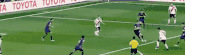 a group of soccer players are playing on a field with a toyota banner behind them