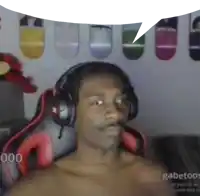 a shirtless man wearing headphones is sitting in a chair with a speech bubble .