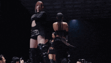 a woman in a black outfit has the number 18 on her sleeve