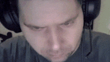 a man wearing headphones and a microphone looks at something