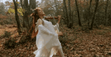 Lindsey Stirling In The Woods GIF - Lindsey Stirling In The Woods White Dress GIFs