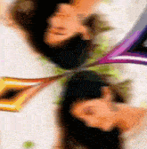 a blurry picture of a person laying on their back with a purple ribbon around their neck