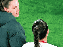 a woman in a blue jacket talks to another woman