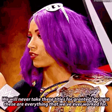 a woman with purple hair talking into a microphone