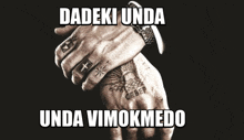 a black and white photo of a man 's hands with the words dadeki unda unda vimokmedo