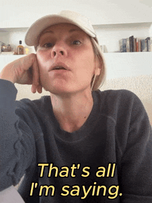 a woman wearing a hat and a black sweater says that 's all i 'm saying