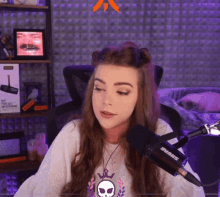 a woman sitting in front of a shure microphone in a room