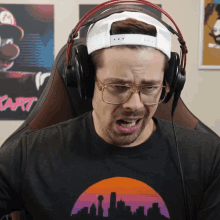 a man wearing glasses and headphones with a shirt that says kart on it