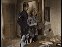 a man and a woman are standing next to each other in a room .