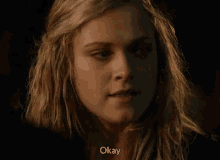 a close up of a woman 's face with the words `` okay '' written below her .