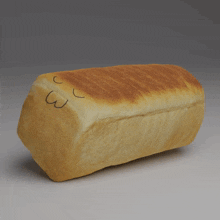 a loaf of bread has a face drawn on it