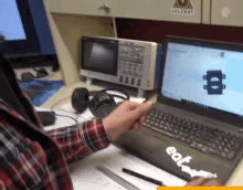 a person is using a laptop with a sticker on it that says eat