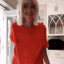 a woman wearing a red t-shirt with the word marvel on the front