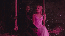 a witch and a princess are sitting on a swing