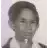 a black and white photo of a young boy wearing a white shirt .