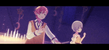a boy and a girl are standing next to each other in a dark room
