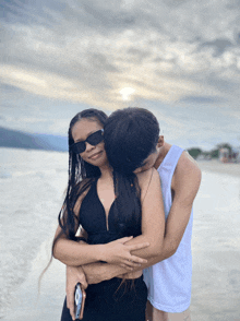 a man is kissing a woman on the forehead