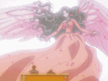 a woman in a pink dress with wings is standing in front of a man in a chair .