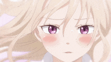 a girl with blonde hair and purple eyes is making a funny face