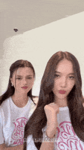 two women are standing next to each other and their shirts say mooduseries on them