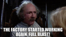 a man with gray hair and a mustache is sitting in a rocking chair with the words the factory started working again full blast .