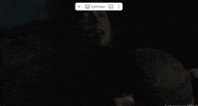 a man is holding a woman 's arm in the dark .