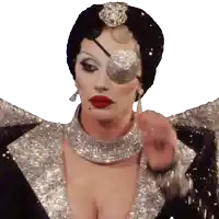 a woman wearing a black and silver costume with a rhinestone eye patch