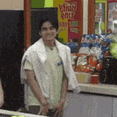 a man is standing in front of a vending machine that says ' etio ' on it