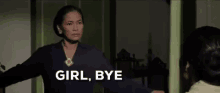a woman is standing in front of a door with the words `` girl bye '' written on it .