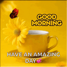 a yellow cup of coffee with a yellow flower and a butterfly on it