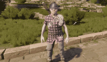 a man wearing a helmet and a checkered shirt is standing on a sidewalk